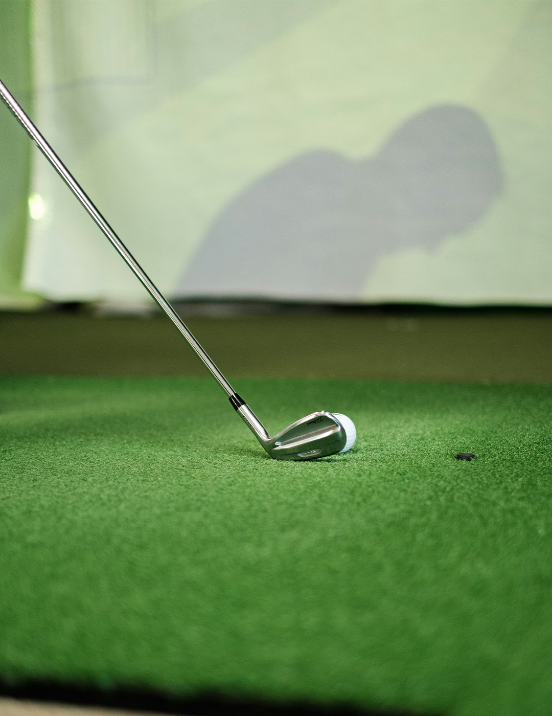Student competing in Fenworks STEM programs for schools on a golf simulator